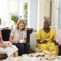 Portrait Of Senior Female Friends Enjoying Afternoon Tea At Home